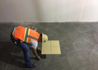 A man started installing tile on the floor