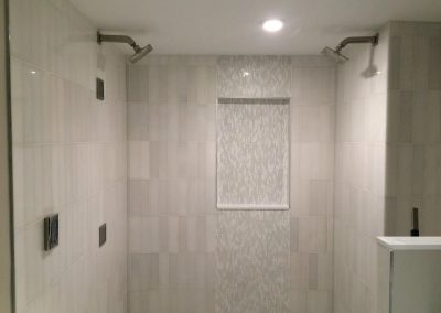 tile floor installation-room with a sink and two shower