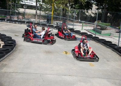 A group of people riding on the back of a kart-4